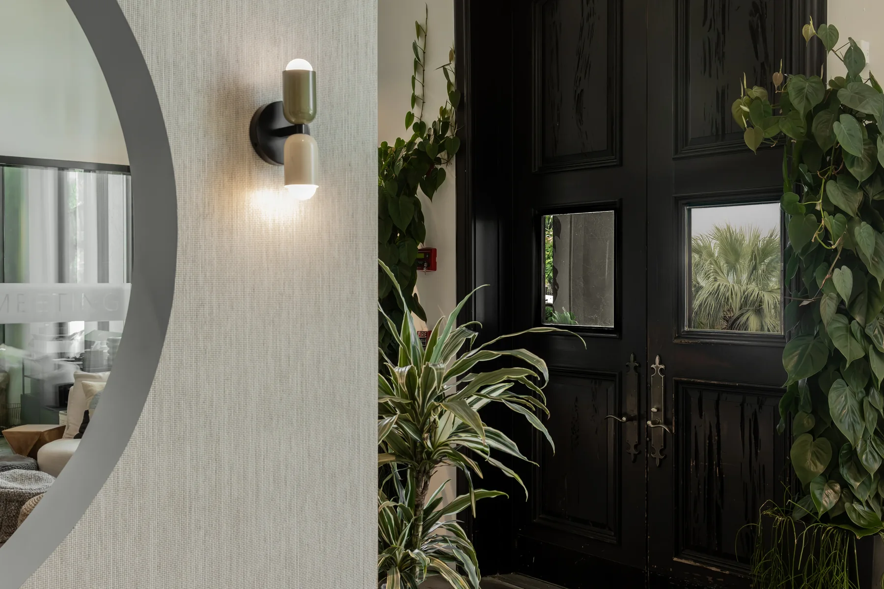 MedHouse interior with sculptural doorway and greenery
